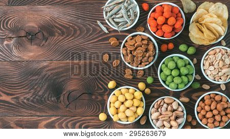 Assortment Of Different Snack For Beer, Wine, Party. Peanuts In Coconut Glaze, Green Vasabi, Red Spi