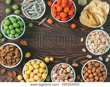 Assortment Of Different Snack For Beer, Wine, Party. Peanuts In Coconut Glaze, Green Vasabi, Red Spi
