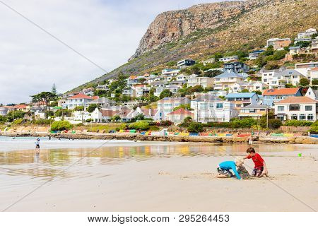 Kids Playing On Fish Hoek Beach On A Cloudy Day