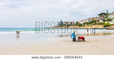Kids Playing On Fish Hoek Beach On A Cloudy Day