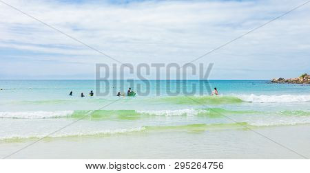 Kids Swimming On Fish Hoek Beach On A Cloudy Day