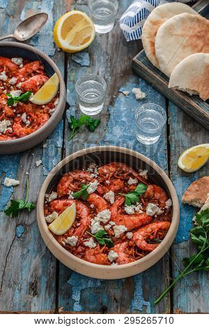 Shrimps Saganaki With Feta Cheese On A Plate On A Table