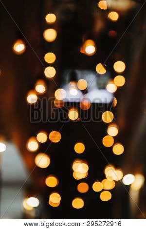Burning Bulb Shines Weakly On The Background Blurred Yellow Lights