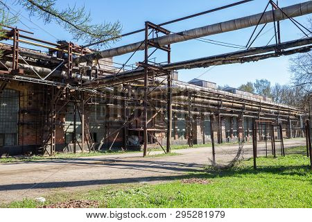 Industry. Old Workshops Of The Izhora Plants, A Brick Building With A Pipeline