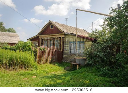 Old Wooden House With A Shadoof At The Entrance In Russian Village