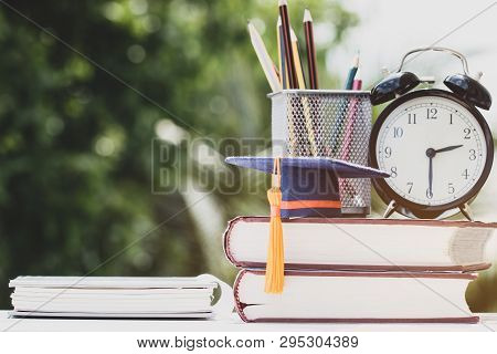 Graduate Or Education Knowledge Study Abroad Concept : Graduation Cap On Textbook With Pencil Box An
