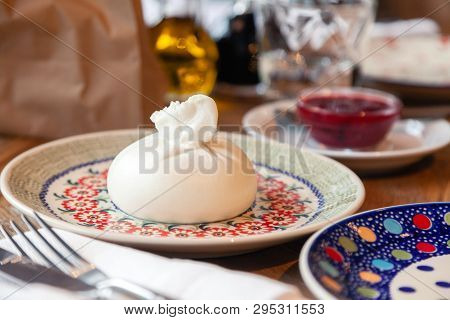 Closeup Fresh Local Italian Soft Round Buratta On Round Color Beautiful Plate With A Pattern Served