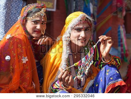Udaipur, India - January 7, 2019: Indian Rajasthani Women In Traditional Clothes Selling Beads At Lo