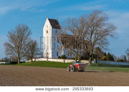 Kalvehave Denmark - April 17. 2018: Farmer On A Massey Ferguson Tractor Spreading Fertilizer With Ka