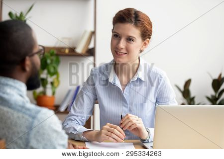 Smiling Hr Manager Listening To African Job Seeker At Interview