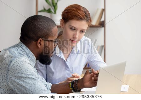 African Mentor Consultant Explaining Computer Work To Caucasian Intern Client