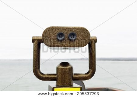 Public Binocular Telescope On The Observation Deck Overlooking The Sea.