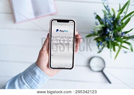 Kharkiv, Ukraine - April 10, 2019: Apple Iphone X In Female Hand With Paypal.com Site On The Screen.
