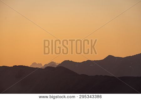 Sunset View From Border Road Of Slovenia And Italy To Mountains Mangart And Kanin In Julian Alps