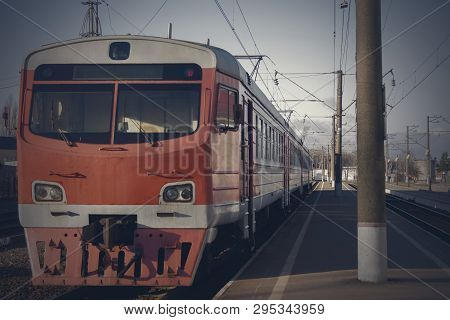 Old Passenger Train, Red. Stands On The Platform.