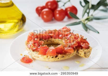 Tipical Summer Dish Of Puglia - Friselle. Classical Frisella With Tomato, Oregano And Olive Oil. Dri