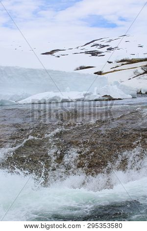 Spring Glacial River Of Melting Snow In Mountains Of Norway