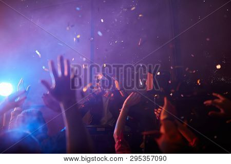 Modern Handsome Young Dj Performer Standing At Record Turntables And Twisting Disc While Creating In
