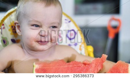 Beautiful Little Boy Eating A Watermelon At The Kids Table And Shaking His Head Happy Smiling Close 