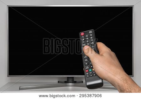 Black Screen On Tv And Human Hand With Tv Remote Controller