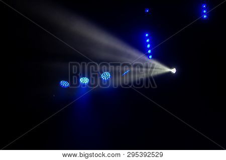 Stage Lights. Several Projectors In The Dark. Multi-colored Light Beams From The Stage Spotlights On