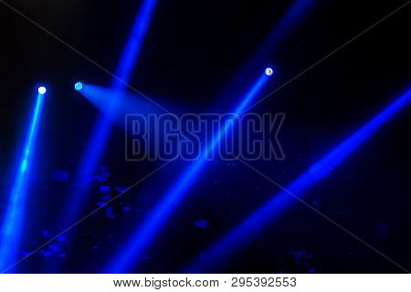 Stage Lights. Several Projectors In The Dark. Multi-colored Light Beams From The Stage Spotlights On