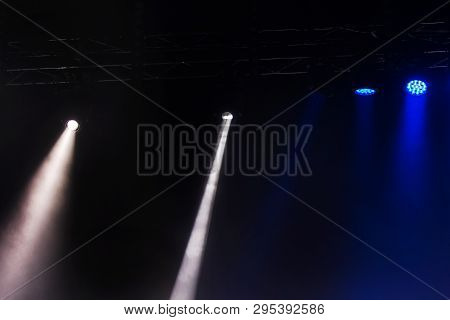 Stage Lights. Several Projectors In The Dark. Multi-colored Light Beams From The Stage Spotlights On