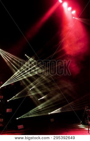 Stage Lights. Several Projectors In The Dark. Multi-colored Light Beams From The Stage Spotlights On