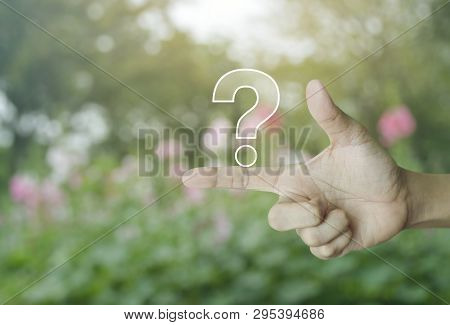 Question Mark Sign Icon On Finger Over Blur Pink Flower And Tree In Park, Business Customer Service 
