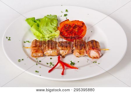 Skewers Of Grilled Meat And Vegetables On The White Plate, Close Up