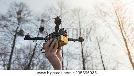 Pilot Racing Drone Holds In His Hand Fpv Copter Before Launching It. A Small High-speed Aircraft Wit