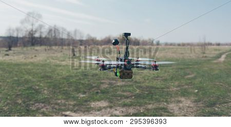 A Small Fpv Racing Drone Is Ready To Fly And Hovered Above The Ground Before The Race. Self-made Fly