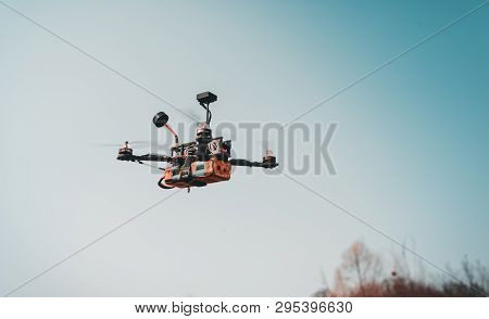 A Small Fpv Racing Drone Is Ready To Fly And Hovered Above The Ground Before The Race. Self-made Fly
