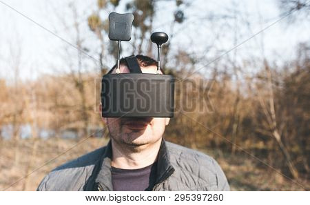 Fpv Drone Pilot In A Virtual Reality Helmet With A Remote Control From A Copter Flies In Aircraft Ou