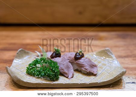 Meat Sushi Nigiri Grilled Or Aburi Served In Brown Plate Decoration With Vegetable On Wooden Table. 