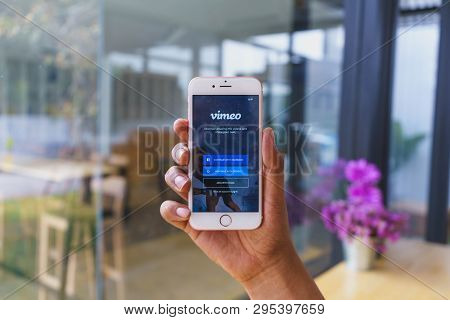 Chiang Mai, Thailand - Mar 02,2018: Man Holding Apple Iphone 6s Rose Gold With Vimeo On Screen.  Vim