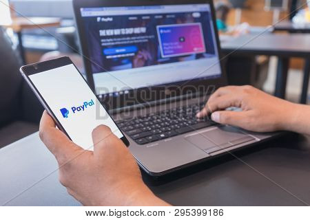 Chiang Mai, Thailand - Mar 18,2018: Man Holding Huawei Gold With Paypal Apps On Screen. Paypal Is An
