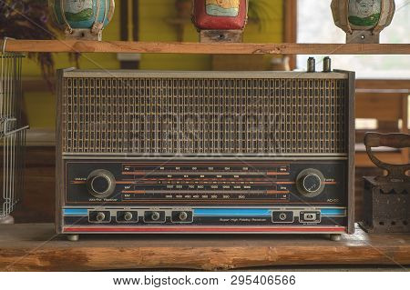 Vintage Retro Radio Transistor On The Wood Shelf. Old Media Sound And Music Equipment.