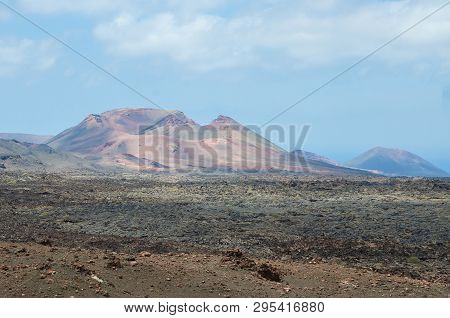 View Of Volcanic Crater In Valle Del Silencio, Valley Of Silence In Timanfaya National Park In Lanza