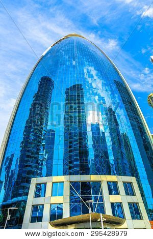 Doha, Qatar - February 17, 2019: Woqod Tower With Its Futuristic Shape And Glazed Reflective Facade 