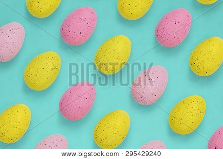 Pink And Yellow Easter Eggs On A Bright Blue Background