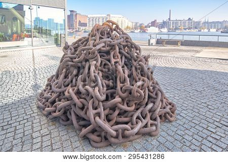 Rusty Anchor Chain Piled Up On The Pier, Close-up
