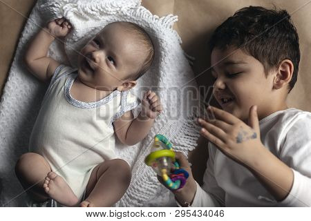 Two Brothers Lying And Posing. Portrait Of Brothers. Two Months Baby Boy And Five Years Small Boy Pl