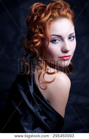Vintage Portrait Of A Glamourous Queen Like Girl Over Wrinkled Black Paper Background. Retro Style. 