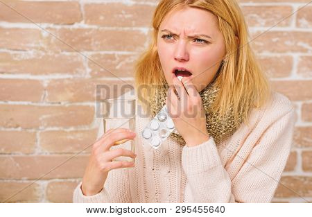 Pills For Breaking Fever. Headache And Fever Remedies. Woman Tousled Hair Scarf Hold Glass Water And