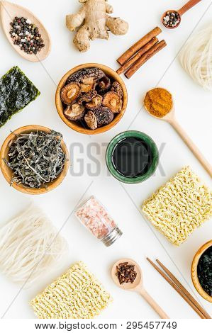 Chinese And Japanese Food Cooking With Ginger, Spices And Noodles On White Background Top View Geome