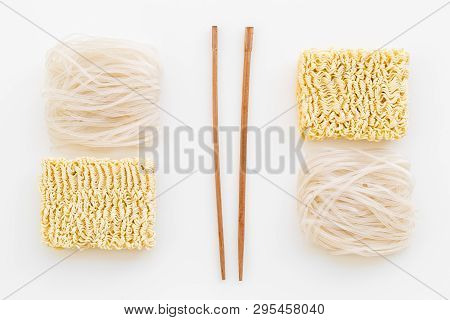 Chinese And Japanese Food Cooking With Rice Vermicelli, Noodles And Sticks White Background Top View