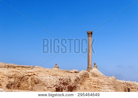 Pompeys Pillar, Roman Triumphal Column, With Two Sphinx Statues Located At The Serapeum Of Alexandri