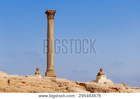 Pompeys Pillar, Roman Triumphal Column, With Two Sphinx Statues Located At The Serapeum Of Alexandri