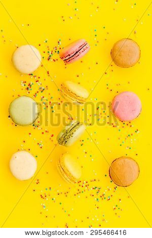Brignt Macarons For Sweet Break On Yellow Background Top View Pattern